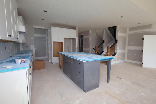 6946 Stillhouse Ln, Dublin, OH 43016 - kitchen with white cabinetry and a kitchen island