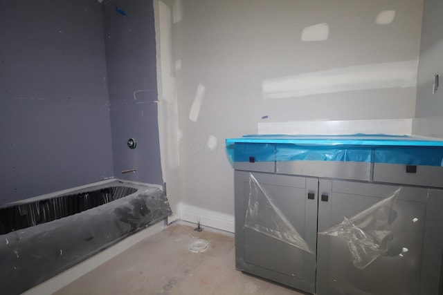 6946 Stillhouse Ln, Dublin, OH 43016 - bathroom with a tub to relax in, unfinished concrete floors, and baseboards