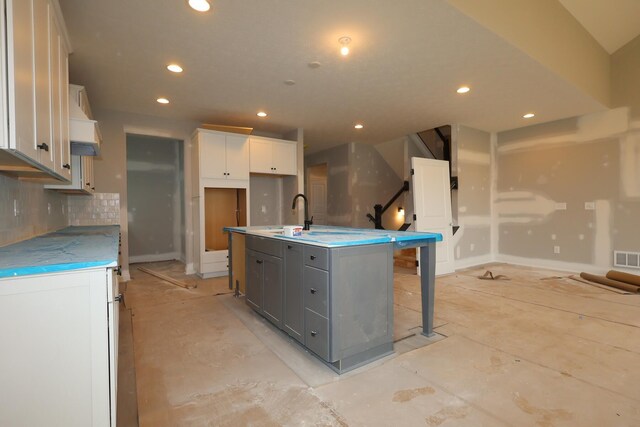 6946 Stillhouse Ln, Dublin, OH 43016 - kitchen featuring recessed lighting, a kitchen island with sink, white cabinets, gray cabinetry, and tasteful backsplash