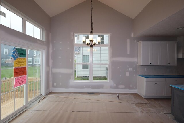 6946 Stillhouse Ln, Dublin, OH 43016 - unfurnished dining area with a chandelier and high vaulted ceiling