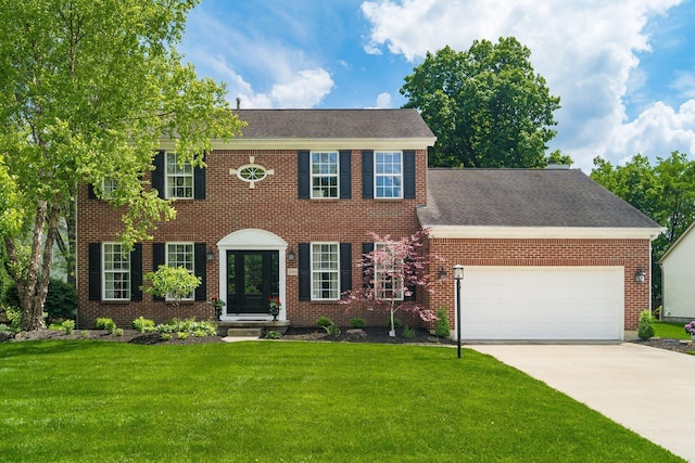 2545 Bryton Dr, Powell, OH 43065 - colonial home with a garage, a front lawn, driveway, and brick siding