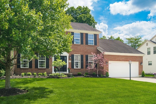 2545 Bryton Dr, Powell, OH 43065 - view of front of home featuring an attached garage, a front lawn, concrete driveway, and brick siding