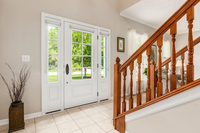 2545 Bryton Dr, Powell, OH 43065 - entryway with light tile patterned flooring, ornamental molding, baseboards, and stairs