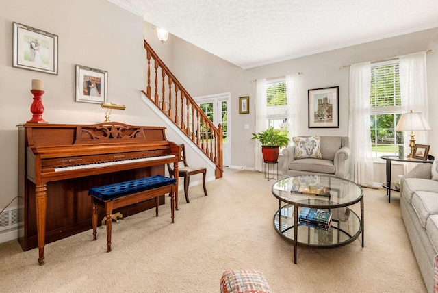2545 Bryton Dr, Powell, OH 43065 - living room featuring light colored carpet, crown molding, stairs, a textured ceiling, and baseboards