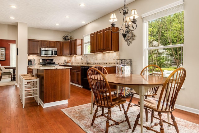 2545 Bryton Dr, Powell, OH 43065 - kitchen featuring appliances with stainless steel finishes, a kitchen island, recessed lighting, tasteful backsplash, and healthy amount of natural light