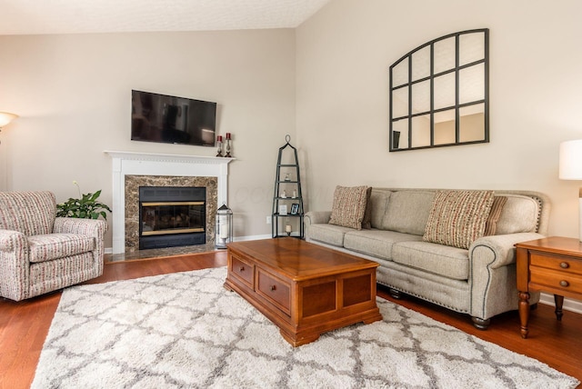 2545 Bryton Dr, Powell, OH 43065 - living area featuring vaulted ceiling, wood finished floors, and a high end fireplace