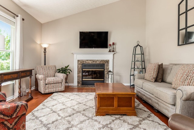2545 Bryton Dr, Powell, OH 43065 - living area with vaulted ceiling, a premium fireplace, wood finished floors, and baseboards