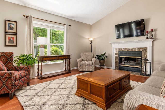 2545 Bryton Dr, Powell, OH 43065 - living room featuring lofted ceiling, wood finished floors, and a fireplace