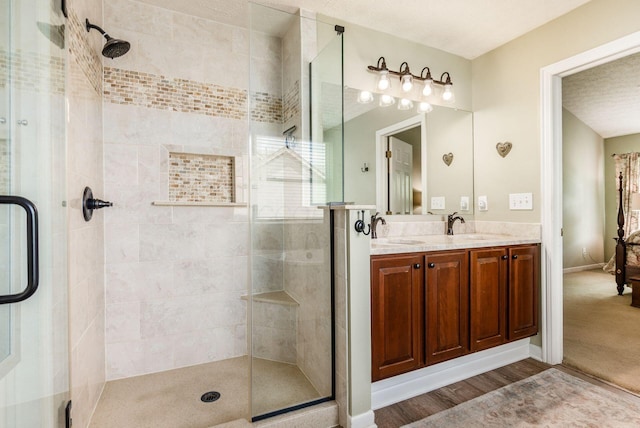 2545 Bryton Dr, Powell, OH 43065 - full bathroom with a stall shower, double vanity, wood finished floors, and baseboards