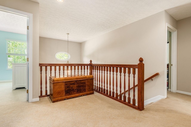 2545 Bryton Dr, Powell, OH 43065 - hall featuring an upstairs landing, carpet flooring, baseboards, and a textured ceiling