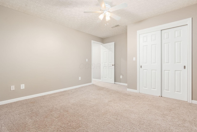 2545 Bryton Dr, Powell, OH 43065 - unfurnished bedroom with a textured ceiling, carpet floors, a closet, baseboards, and ceiling fan