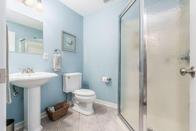 2545 Bryton Dr, Powell, OH 43065 - bathroom with a shower stall, toilet, tile patterned floors, baseboards, and a textured ceiling