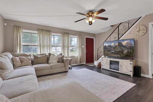 2971 Wendy Ln, Grove City, OH 43123 - living area featuring baseboards, dark wood-style flooring, a ceiling fan, and a glass covered fireplace