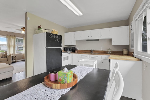 2971 Wendy Ln, Grove City, OH 43123 - kitchen with stainless steel microwave, freestanding refrigerator, a sink, ceiling fan, and white cabinetry