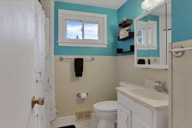 2971 Wendy Ln, Grove City, OH 43123 - bathroom with tile walls, toilet, vanity, a wainscoted wall, and a shower with shower curtain