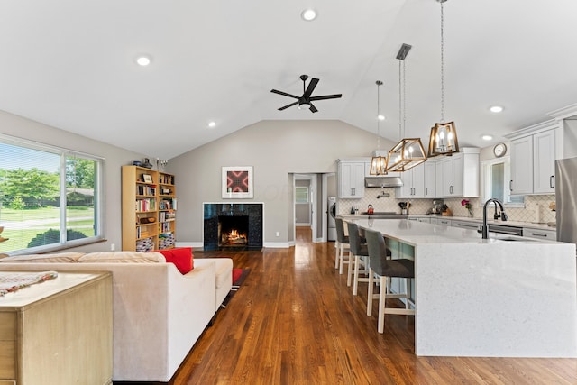 3531 Colchester Rd, Upper Arlington, OH 43221 - living room featuring a premium fireplace, a ceiling fan, dark wood finished floors, vaulted ceiling, and recessed lighting