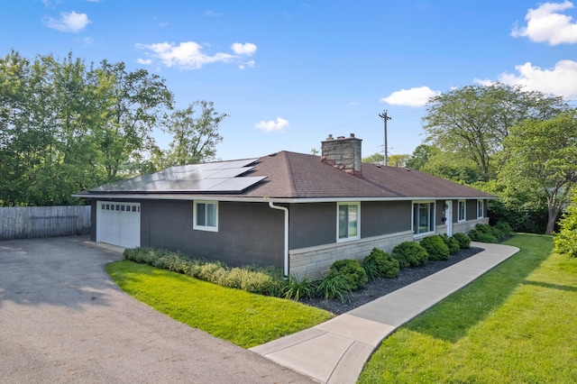 3531 Colchester Rd, Upper Arlington, OH 43221 - view of home's exterior featuring solar panels, a garage, stucco siding, driveway, and a chimney