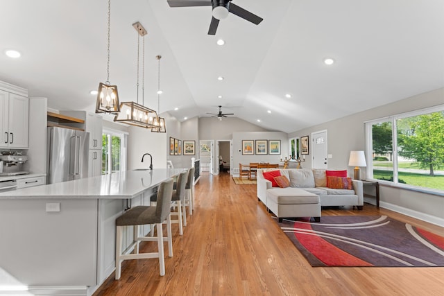 3531 Colchester Rd, Upper Arlington, OH 43221 - living area with ceiling fan, vaulted ceiling, light wood-type flooring, a chandelier, and recessed lighting