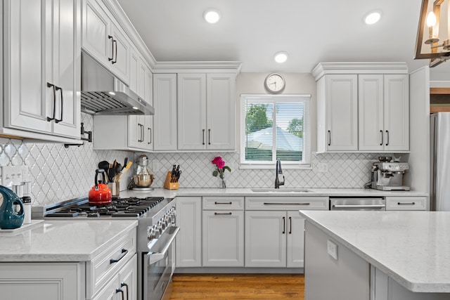 3531 Colchester Rd, Upper Arlington, OH 43221 - kitchen featuring stainless steel appliances, a sink, under cabinet range hood, backsplash, and light stone counters
