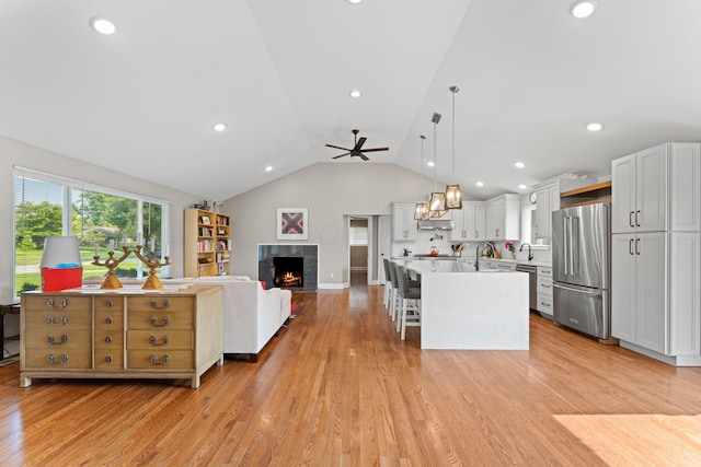3531 Colchester Rd, Upper Arlington, OH 43221 - living area with lofted ceiling, light wood-style floors, a ceiling fan, a premium fireplace, and recessed lighting