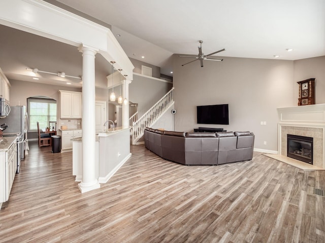 6868 Beltain Ln Unit 37B, Dublin, OH 43016 - living room featuring ceiling fan, light wood-type flooring, a fireplace, recessed lighting, and arched walkways