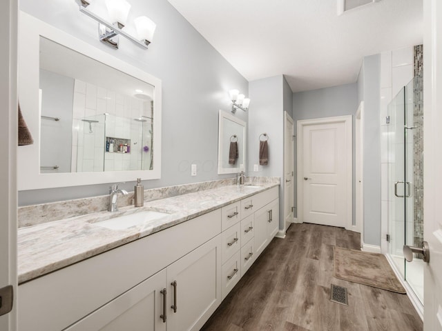 6868 Beltain Ln Unit 37B, Dublin, OH 43016 - full bathroom with wood finished floors, a shower stall, and double vanity