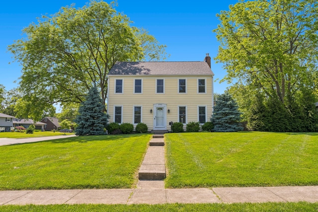 3985 Glenda Pl, Upper Arlington, OH 43220 - colonial home featuring a chimney and a front lawn
