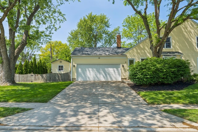3985 Glenda Pl, Upper Arlington, OH 43220 - view of front of home featuring an attached garage, a chimney, and concrete driveway