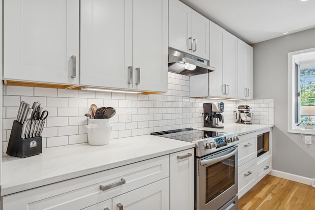 3985 Glenda Pl, Upper Arlington, OH 43220 - kitchen featuring stainless steel range with electric cooktop, under cabinet range hood, baseboards, light wood-style floors, and light stone counters