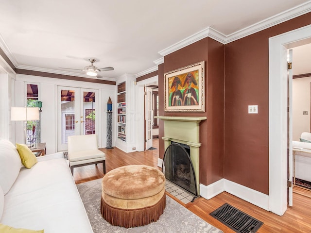 1635 Cambridge Blvd, Upper Arlington, OH 43212 - living room with ornamental molding, french doors, a fireplace with flush hearth, wood finished floors, and baseboards