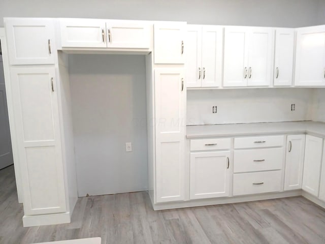 15848 Barnes Dr, Belle Center, OH 43310 - kitchen with white cabinetry, light countertops, and light wood-type flooring