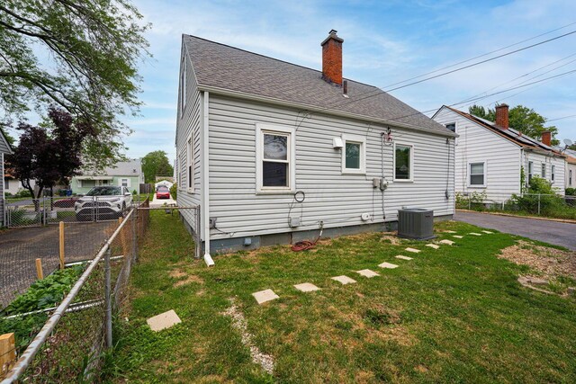 831 E Longview Ave, Columbus, OH 43224 - rear view of property with a chimney, central AC unit, roof with shingles, and crawl space