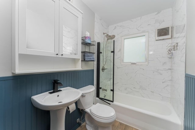 831 E Longview Ave, Columbus, OH 43224 - full bathroom with wainscoting, toilet, washtub / shower combination, and wood finished floors