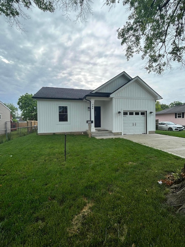 944 Binns Blvd, Columbus, OH 43204 - view of front of property with a garage, board and batten siding, and concrete driveway