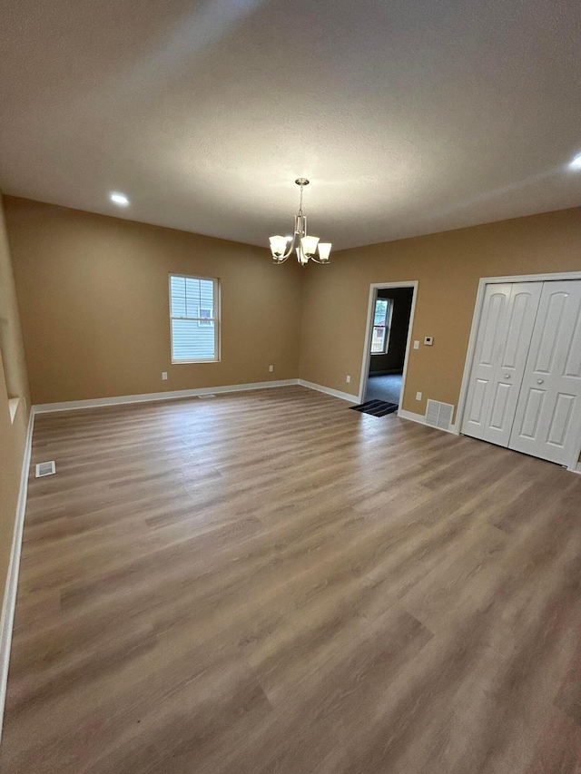 944 Binns Blvd, Columbus, OH 43204 - spare room with a chandelier, wood finished floors, baseboards, and recessed lighting