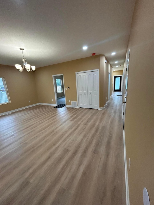 944 Binns Blvd, Columbus, OH 43204 - unfurnished living room featuring light wood-style flooring, baseboards, recessed lighting, a chandelier, and plenty of natural light