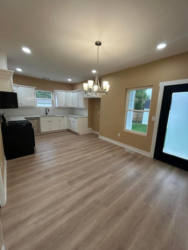 944 Binns Blvd, Columbus, OH 43204 - unfurnished dining area featuring a chandelier, healthy amount of natural light, light wood-type flooring, recessed lighting, and baseboards