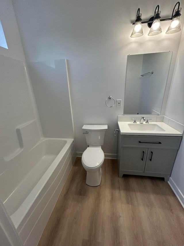 944 Binns Blvd, Columbus, OH 43204 - full bath with wood finished floors, toilet, vanity, baseboards, and bathing tub / shower combination