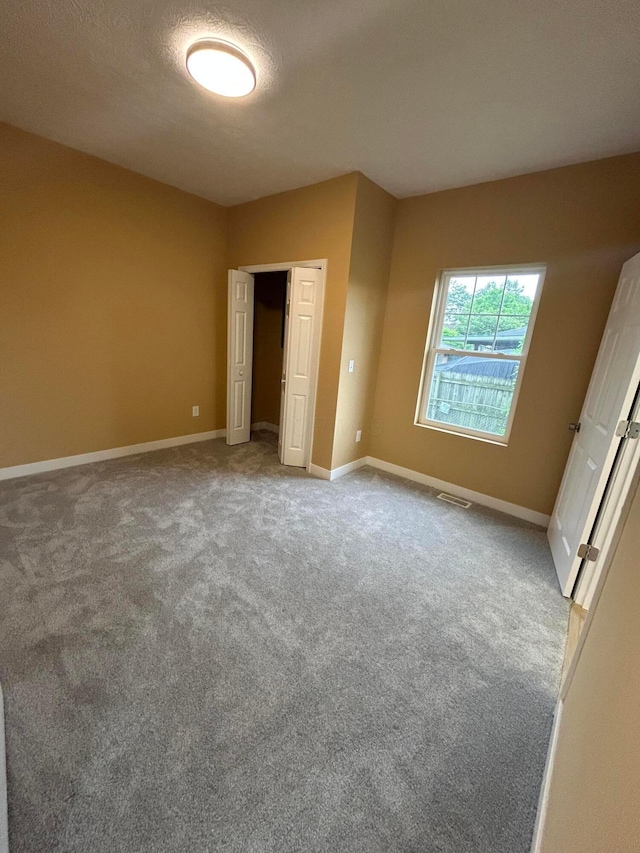 944 Binns Blvd, Columbus, OH 43204 - unfurnished bedroom with carpet flooring, a closet, and baseboards