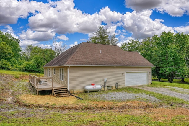 9805 Beaver Pike, Jackson, OH 45640 - view of side of home with a garage, a wooden deck, and roof with shingles