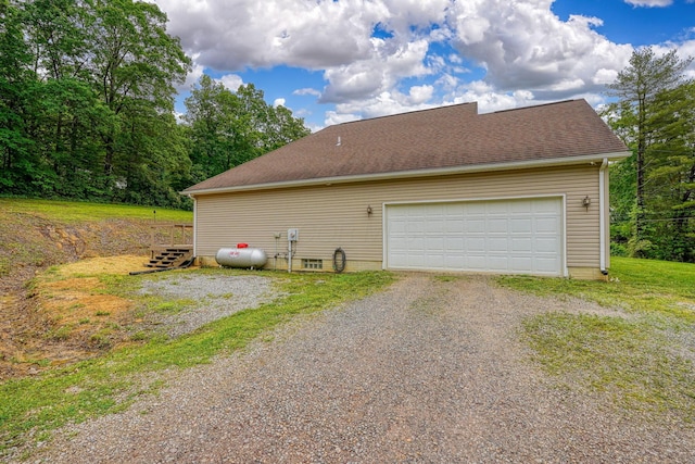 9805 Beaver Pike, Jackson, OH 45640 - view of property exterior featuring a garage, gravel driveway, and a shingled roof