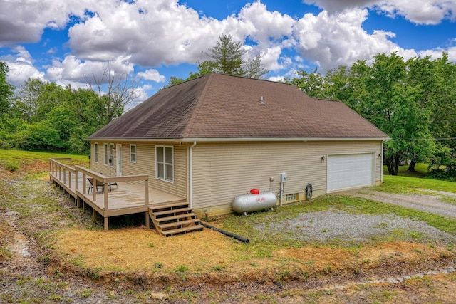9805 Beaver Pike, Jackson, OH 45640 - back of property with a deck, a shingled roof, and a garage