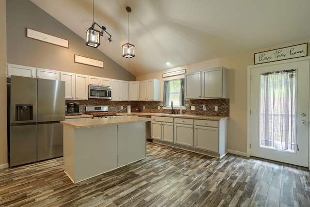 9805 Beaver Pike, Jackson, OH 45640 - kitchen with appliances with stainless steel finishes, vaulted ceiling, dark wood finished floors, decorative backsplash, and a kitchen island