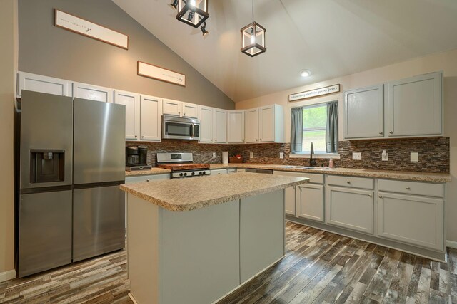 9805 Beaver Pike, Jackson, OH 45640 - kitchen with appliances with stainless steel finishes, a sink, lofted ceiling, dark wood finished floors, and decorative backsplash