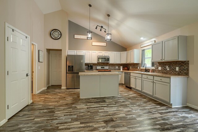 9805 Beaver Pike, Jackson, OH 45640 - kitchen with appliances with stainless steel finishes, a sink, dark wood-type flooring, high vaulted ceiling, and tasteful backsplash