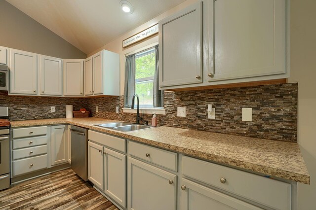 9805 Beaver Pike, Jackson, OH 45640 - kitchen with a sink, stainless steel appliances, lofted ceiling, decorative backsplash, and light countertops