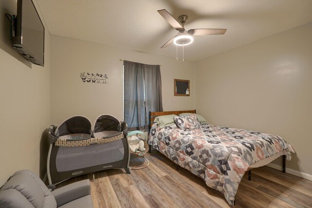 9805 Beaver Pike, Jackson, OH 45640 - bedroom with wood finished floors, a ceiling fan, and baseboards