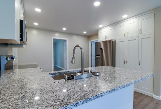 1541 Taft St, Marion, OH 43302 - kitchen featuring appliances with stainless steel finishes, a sink, light stone counters, white cabinets, and recessed lighting
