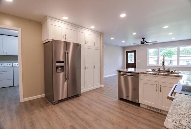 1541 Taft St, Marion, OH 43302 - kitchen with stainless steel appliances, washer and clothes dryer, a sink, light wood finished floors, and recessed lighting