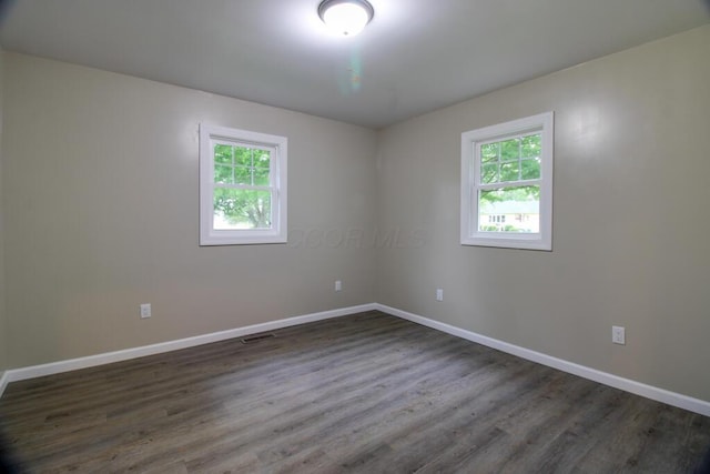 1541 Taft St, Marion, OH 43302 - empty room with plenty of natural light, baseboards, and dark wood finished floors